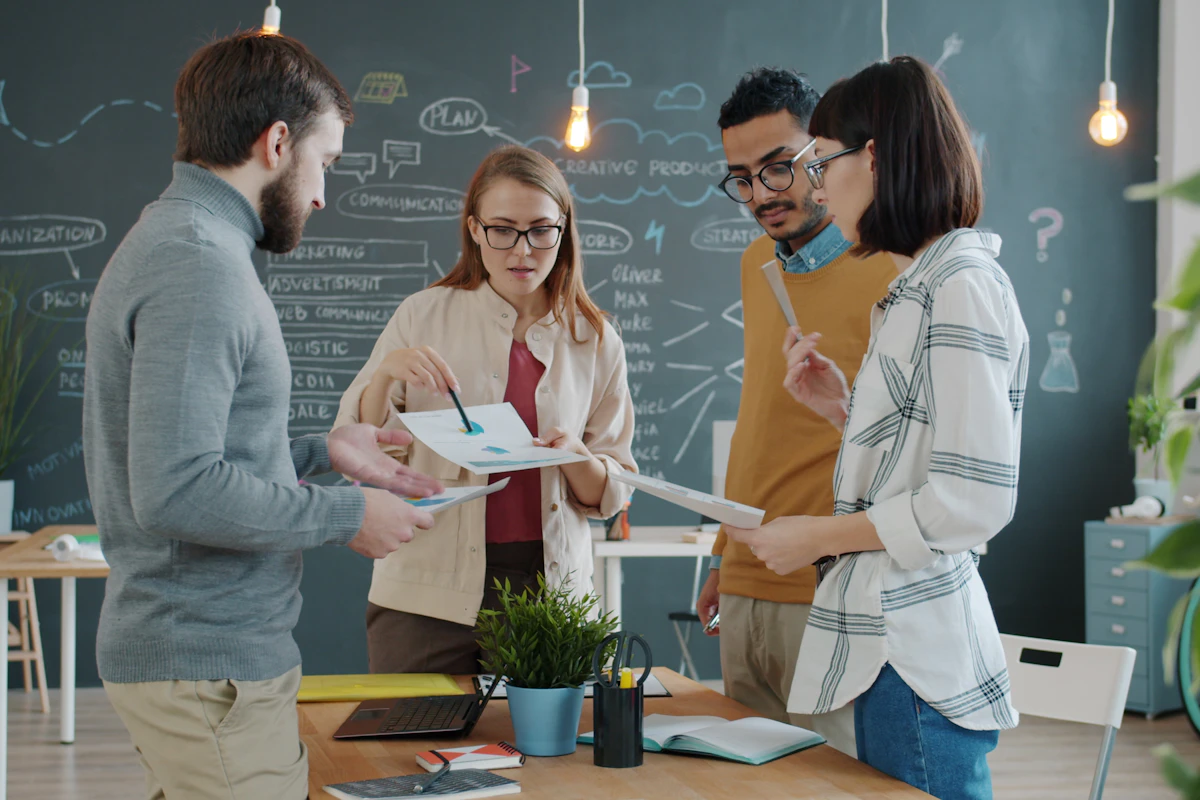 A creative agency team reviewing documents and charts together