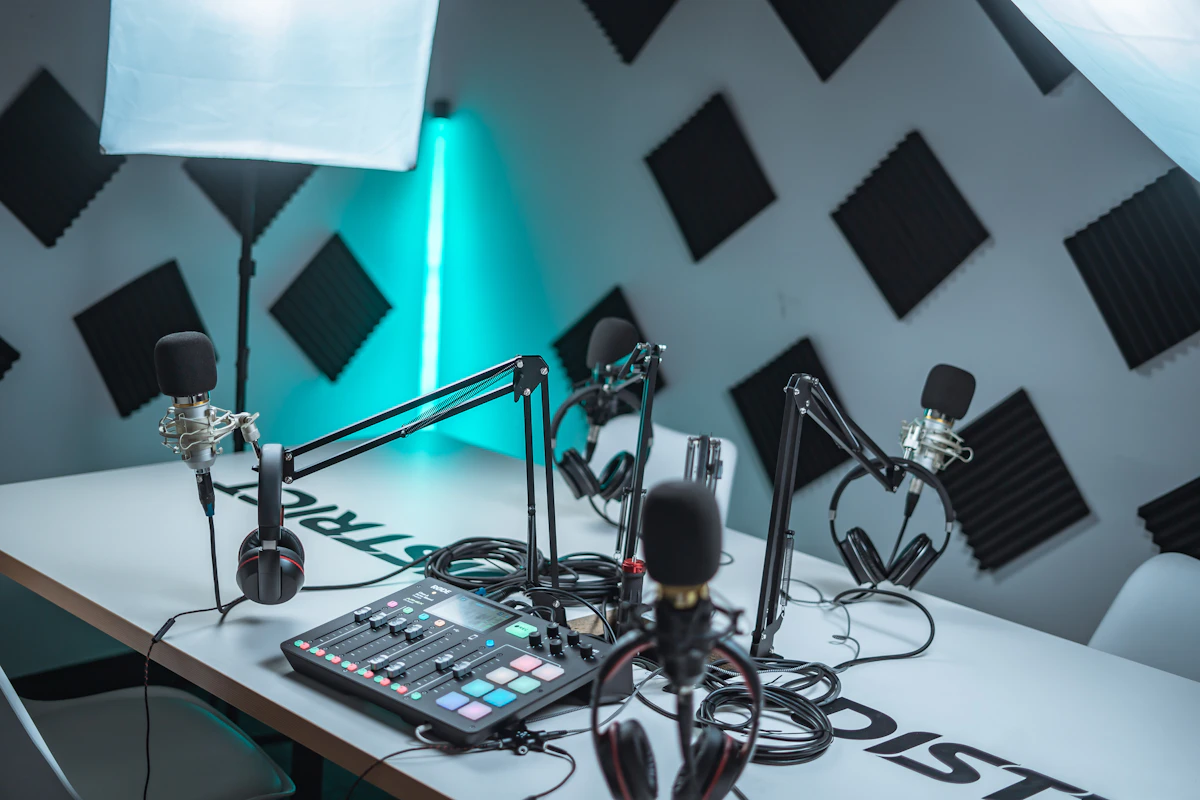 A podcast recording studio with microphones, headphones, and computers