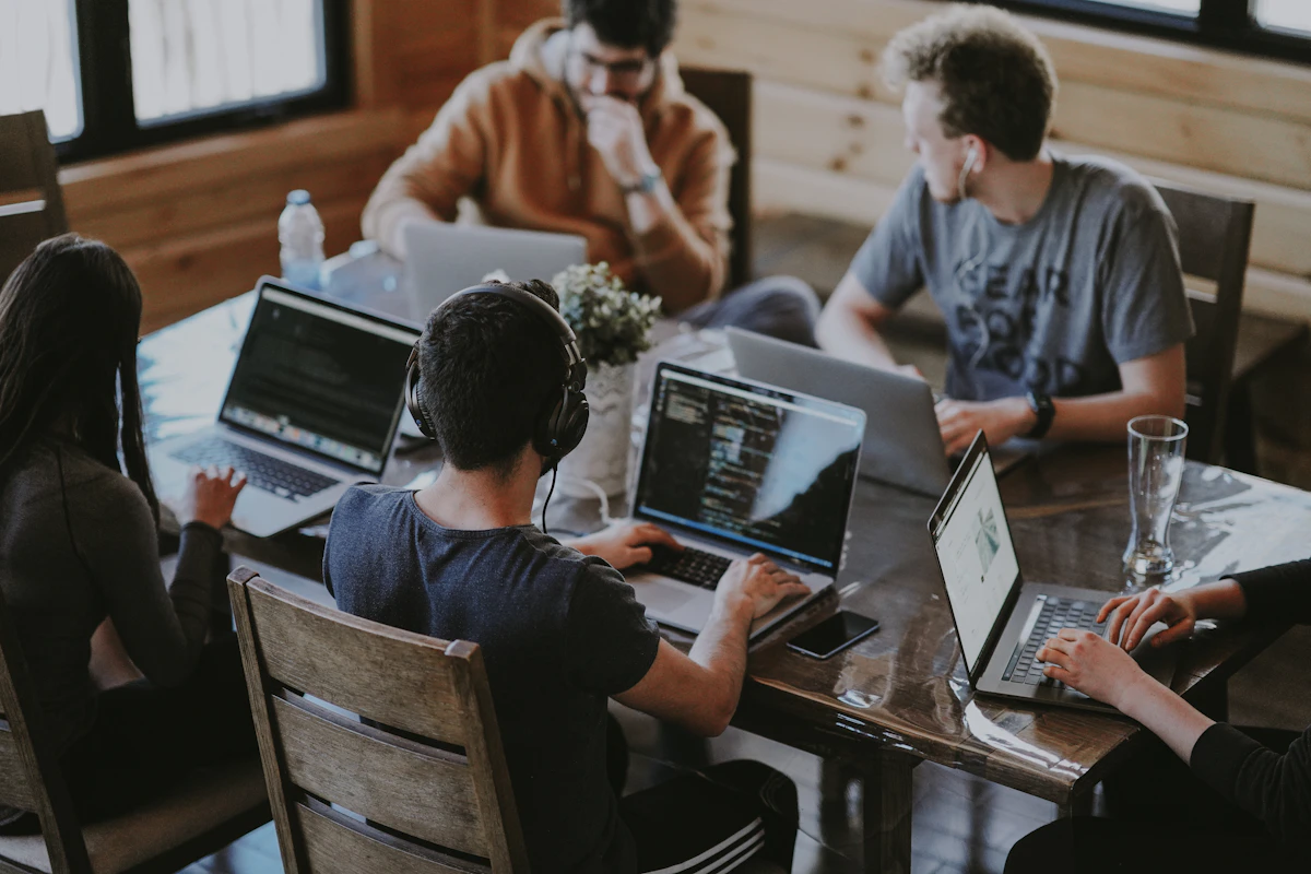 A small team working together around a laptop